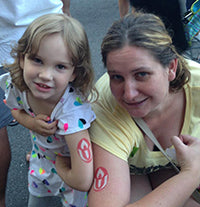 image of a child and adult showcasing chalice temporary tattoo on their upper arms