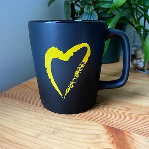 image of Side With Love yellow heart on black mug