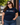 Woman wearing a navy blue t-shirt with 'UU the VOTE' text and logo outdoors.