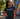 Woman wearing a navy blue t-shirt with 'UU the Vote' logo, standing outdoors 